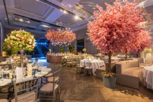 Pink Artificial Cherry Tree Decorations and Flower Arrangements at a Luxury Wedding Ceremony